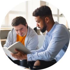 man reading a book with his
               buddy