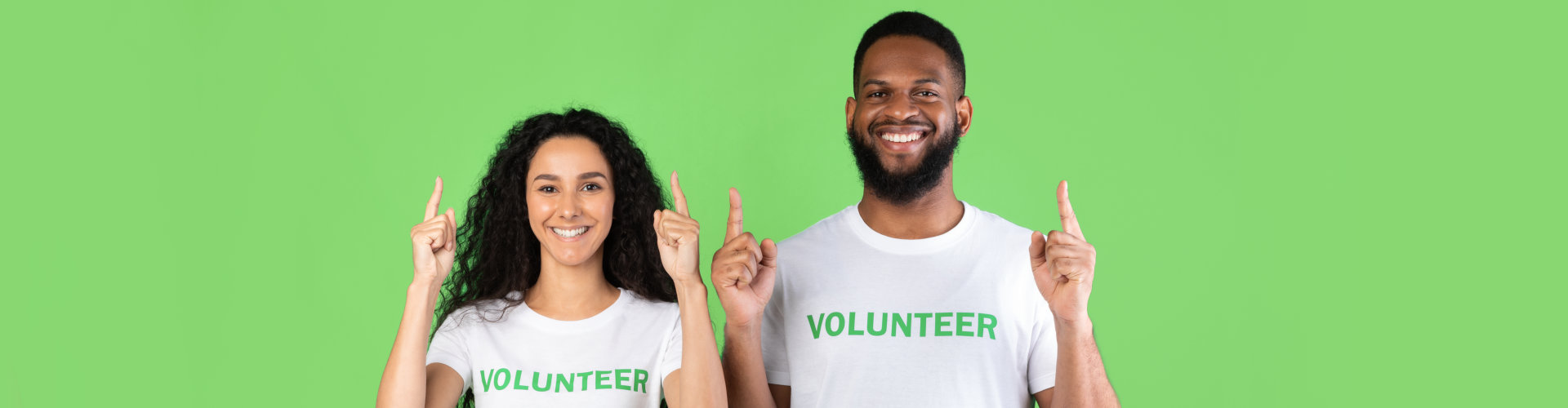 two volunteers smiling