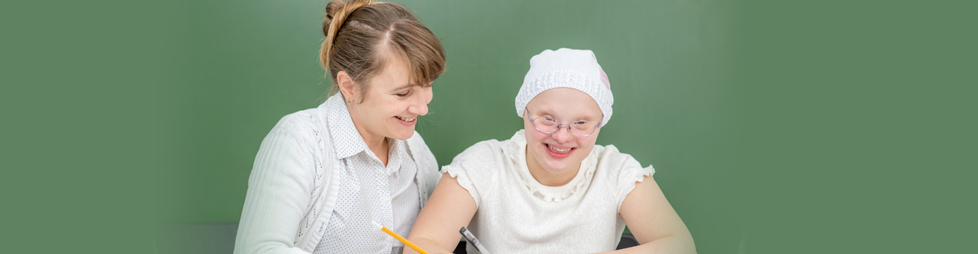 Teacher helps young girl with Down Syndrome